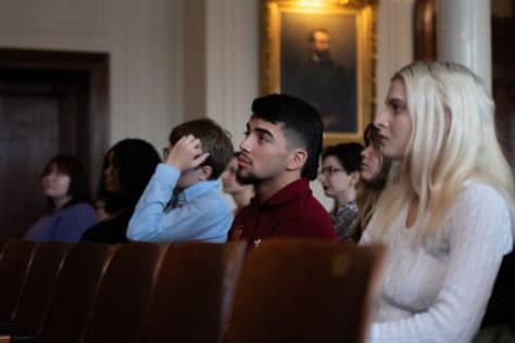 Students seated in Old Main during ceremony